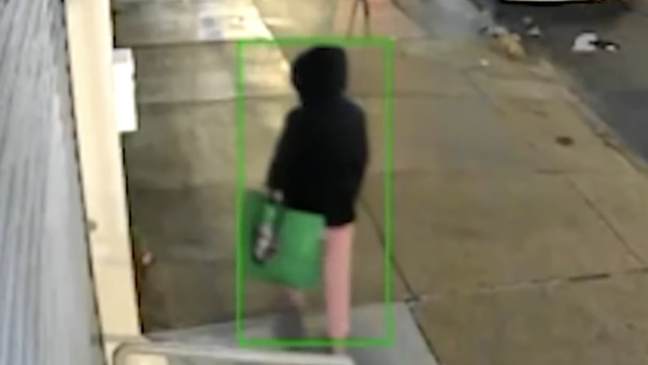 Woman carrying a shopping bag with a baby on a surveillance camera in the Bronx